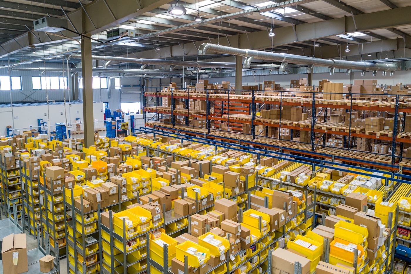 Autonomous mobile robot navigating a warehouse aisle during fleet management training